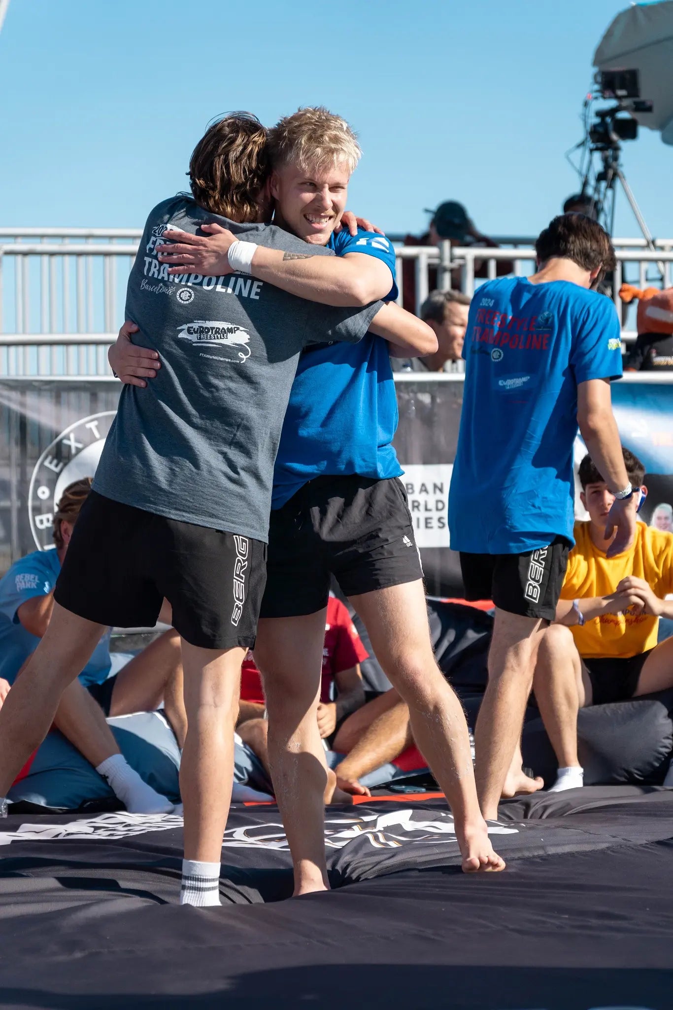 Freestyle trampoline athletes hugging each other at the 2024 World Championships in Barcelona.