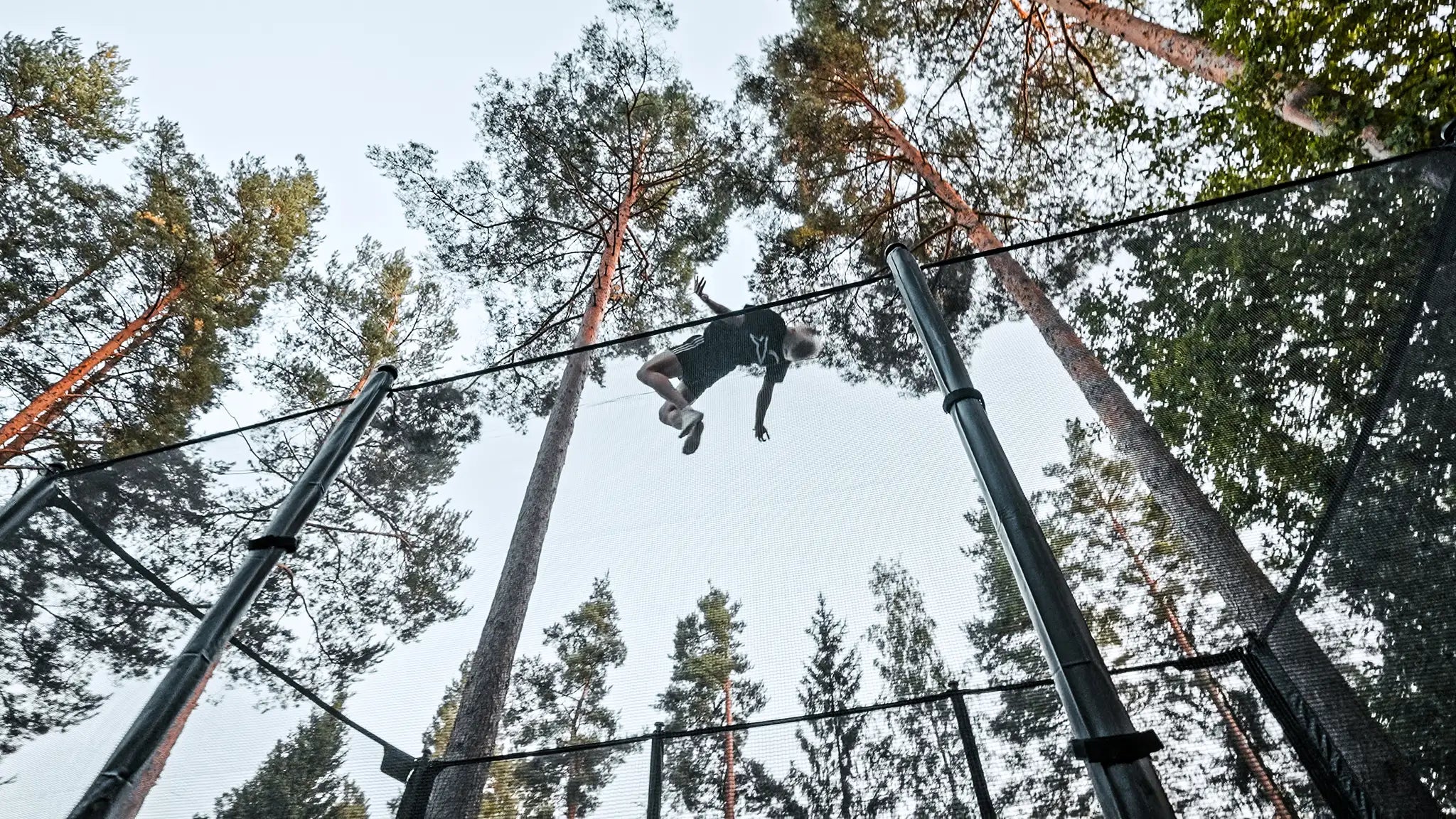 Man doing a high backflip on an Acon X trampoline.