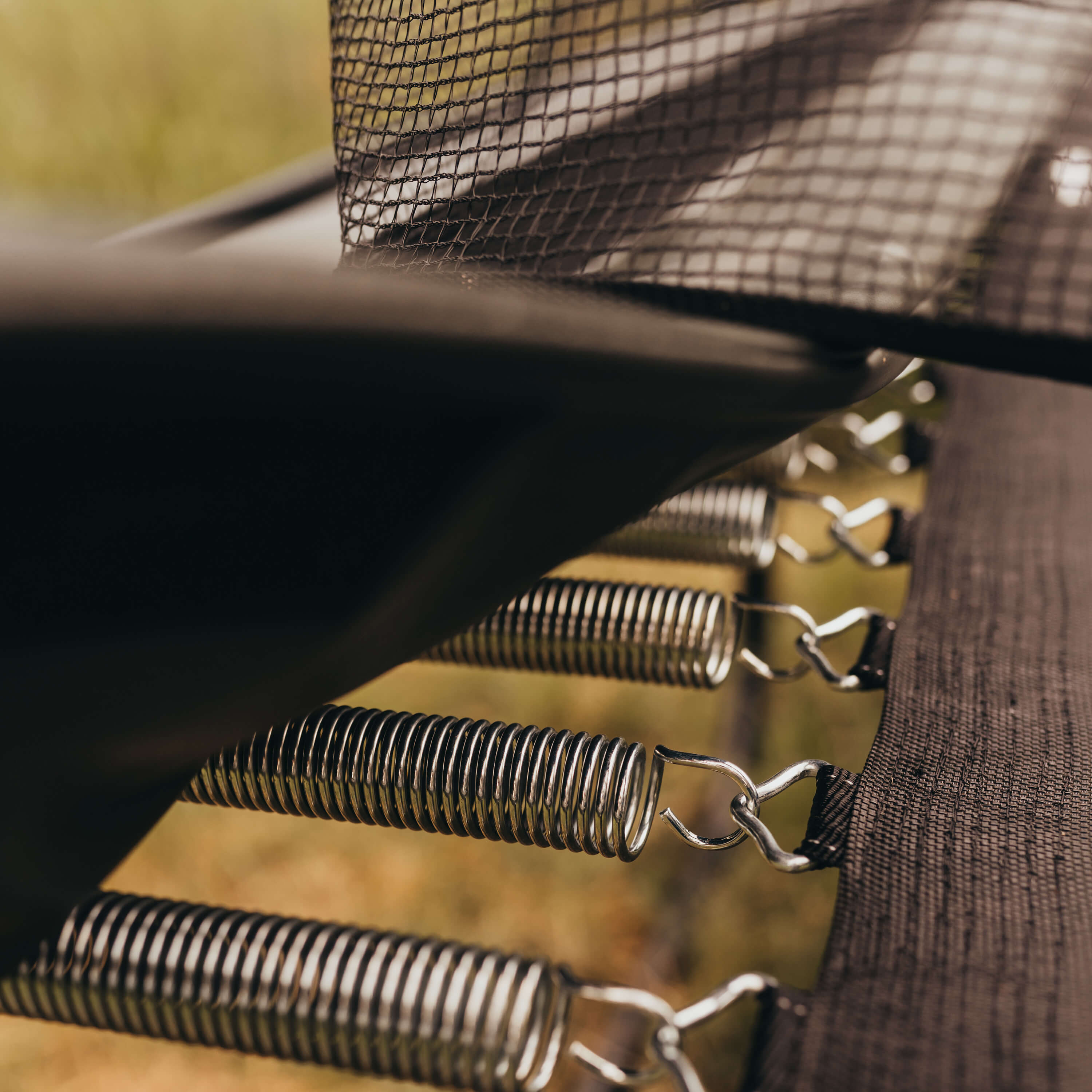 A closeup of trampoline springs and padding