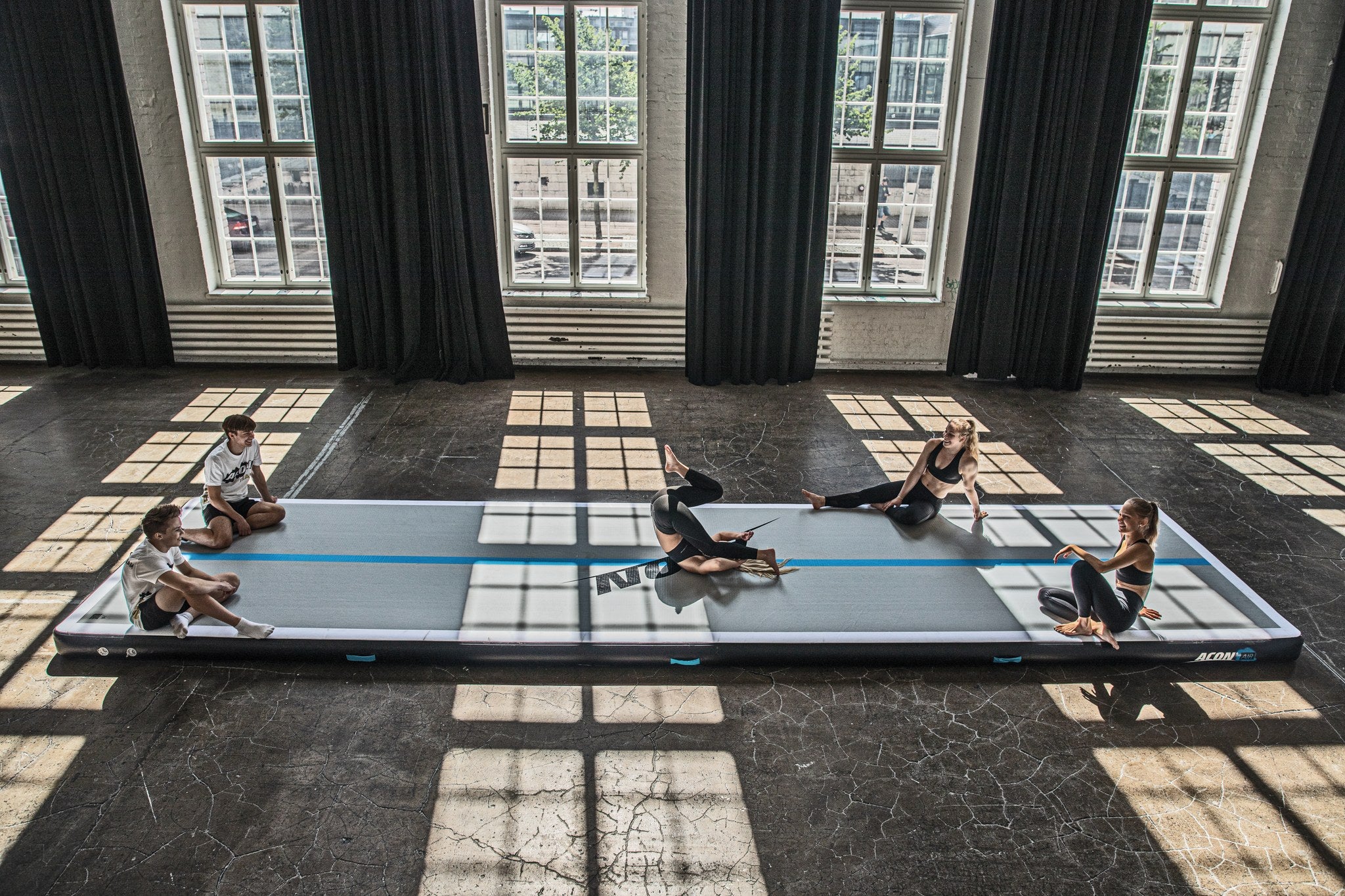 Five gymnasts on one big Airtrack
