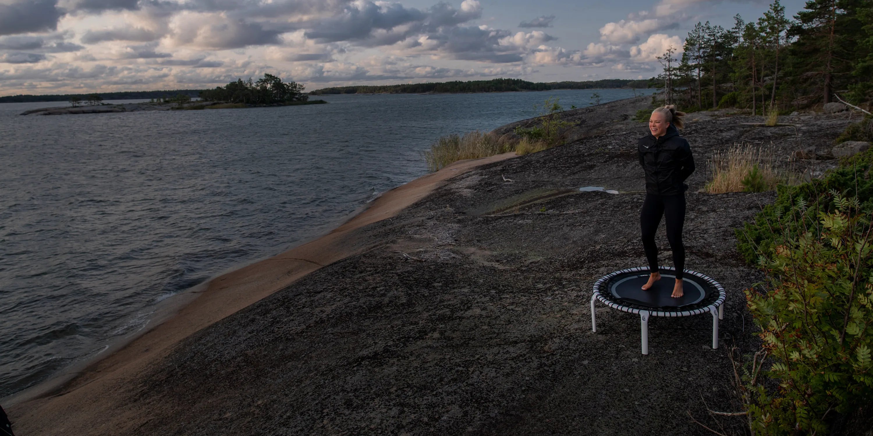 Fit 44in Round Rebounder with Balance Handlebar in use for a fitness session by the Canadian lakeside.