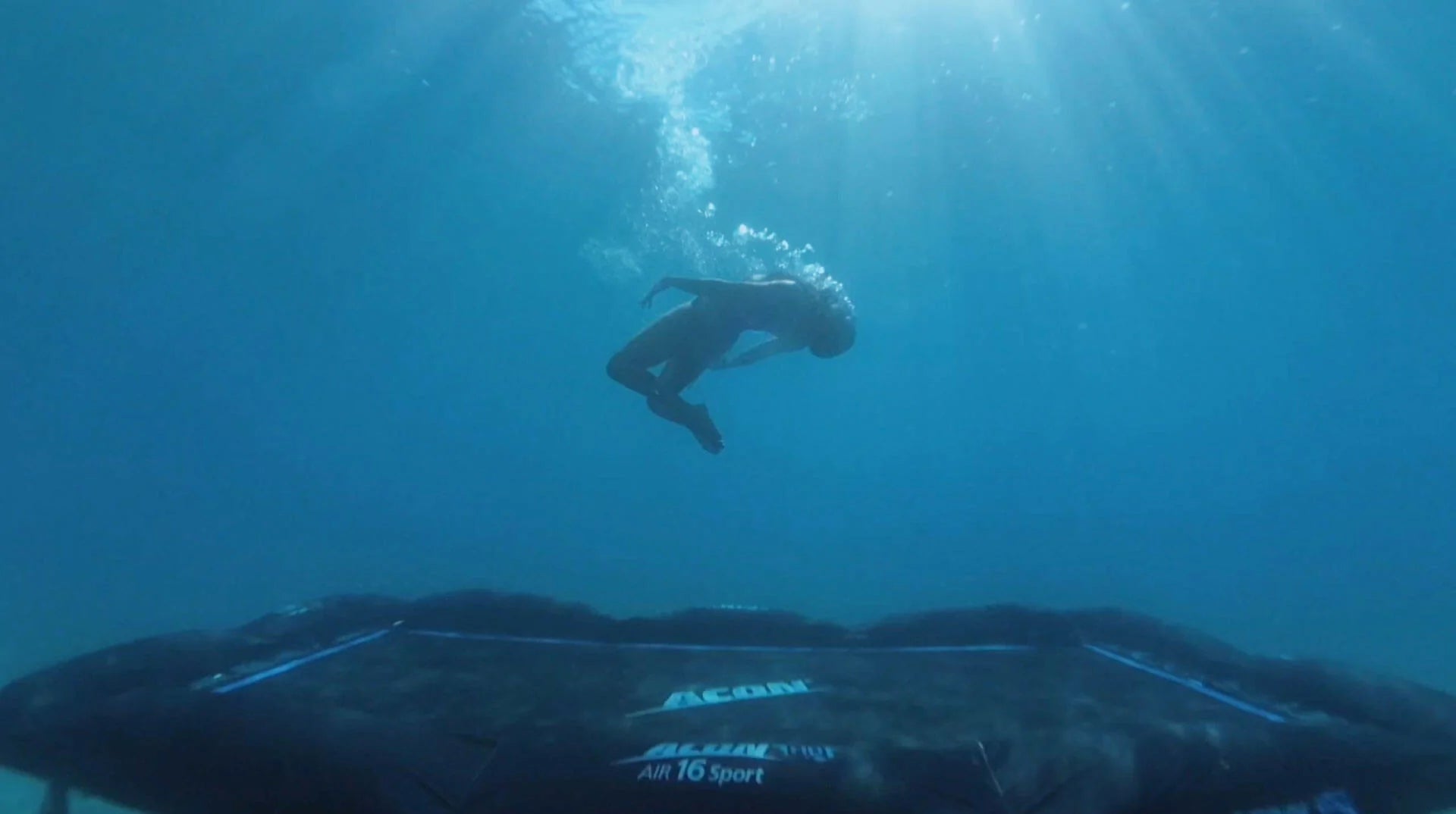 A person jumping on a trampoline underwater