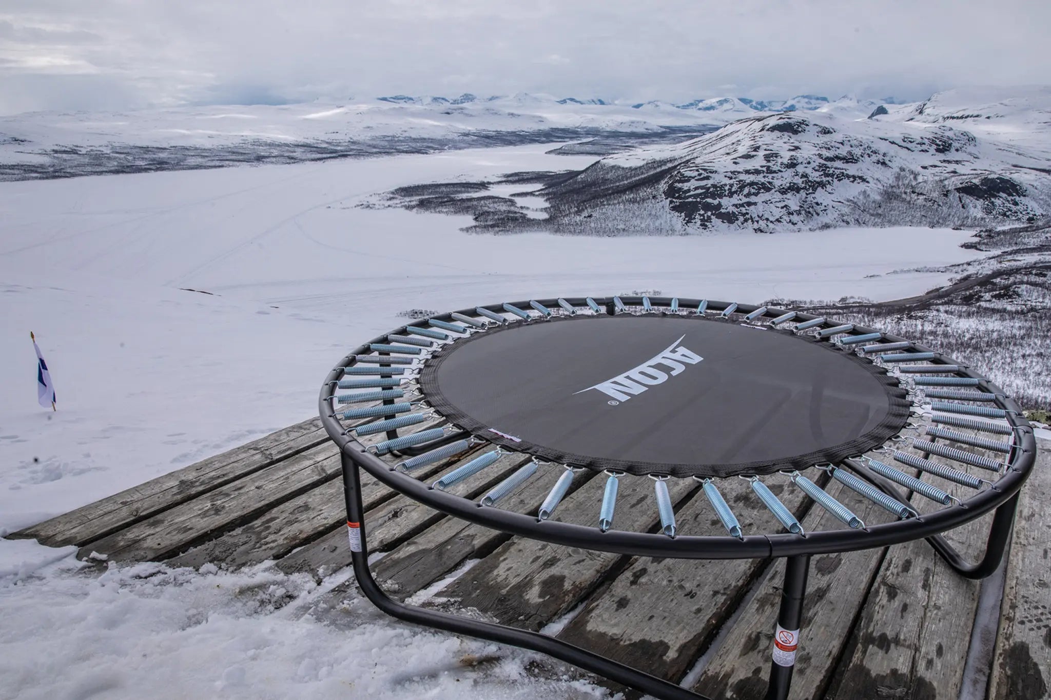 Acon trampoline in the mountains with snow around. 