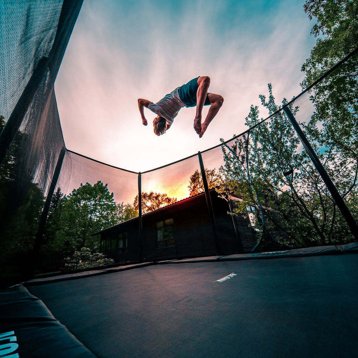 Boy doing a trick on a Acon trampoline.