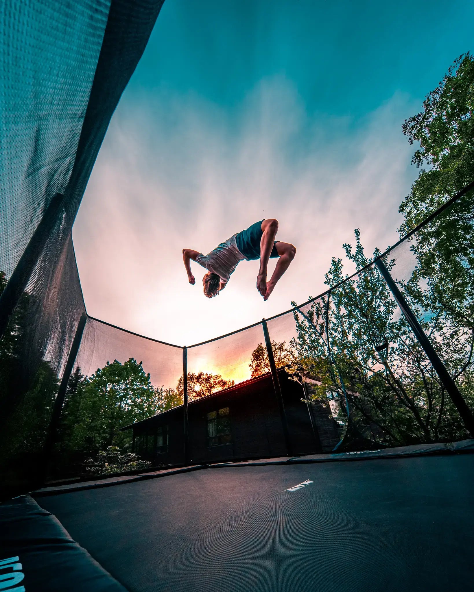 Boy doing a trick on a Acon trampoline. 