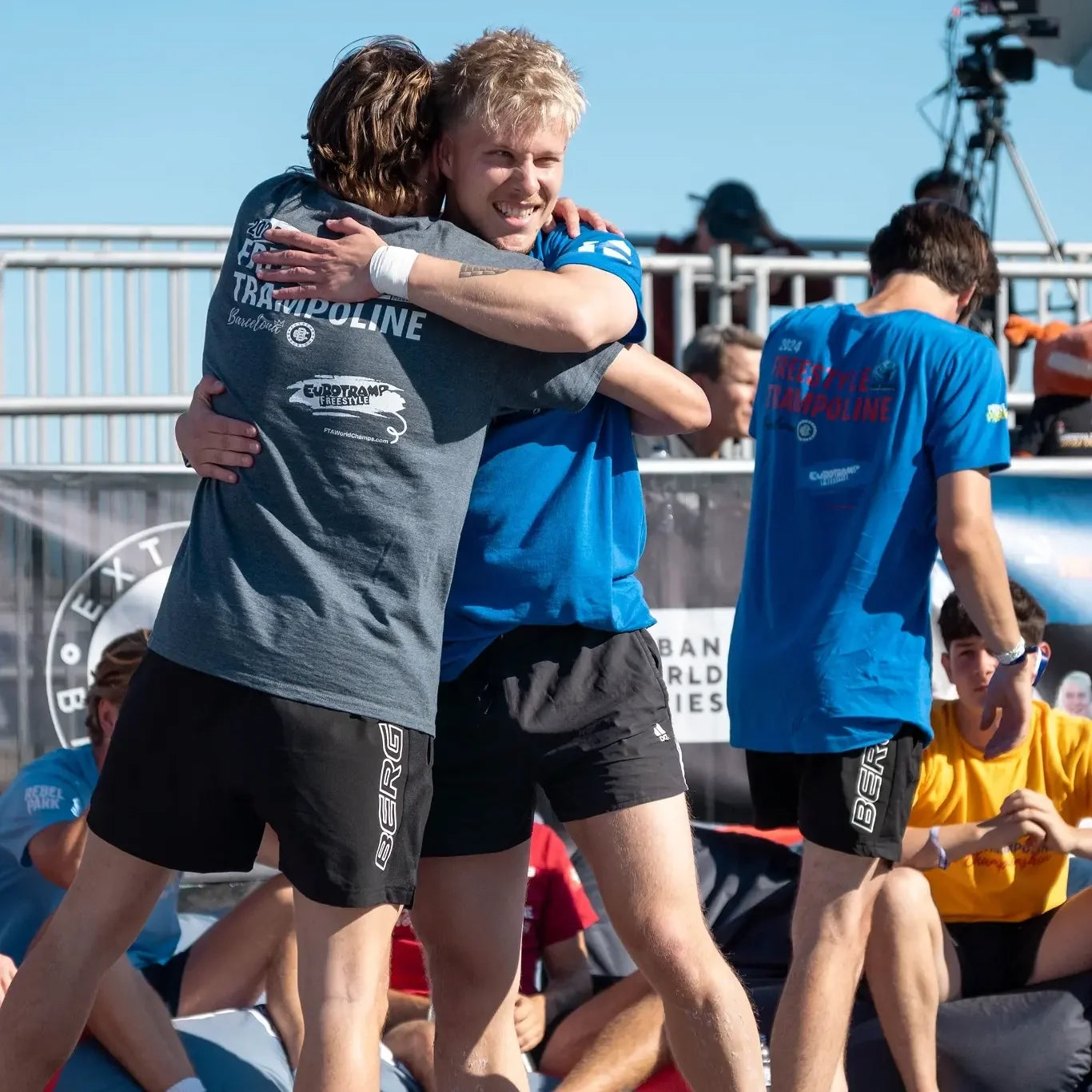 Freestyle trampoline athletes hugging each other at the 2024 World Championships in Barcelona.