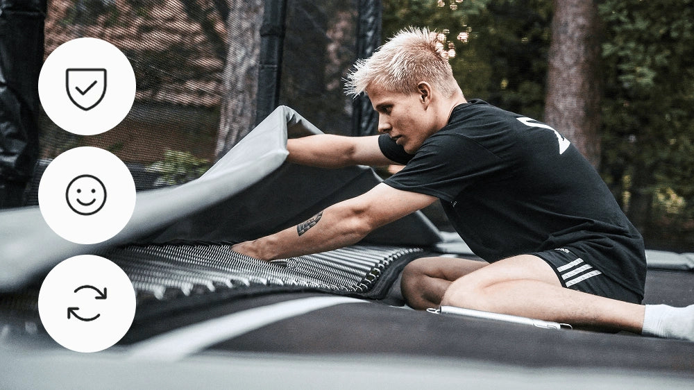 Person installing springs on an Acon trampoline with safety, satisfaction and recycling icons.