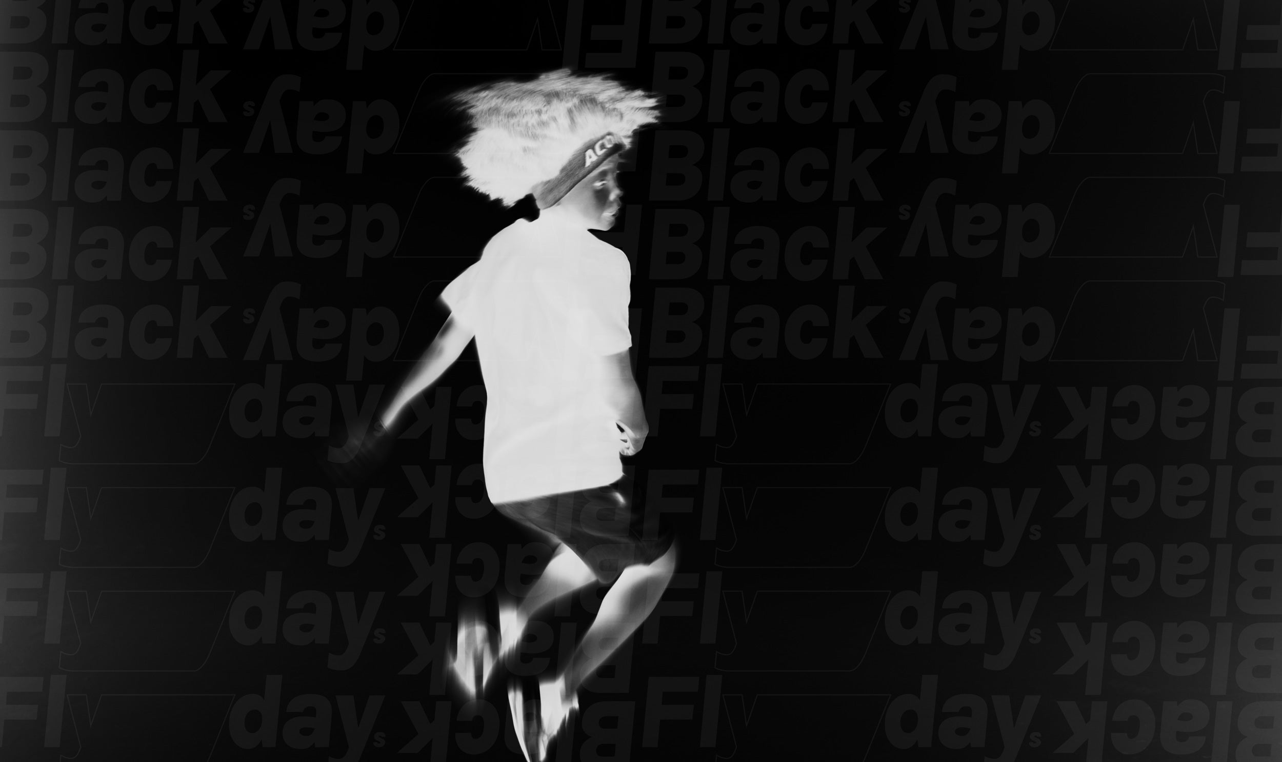 Black and white negative picture of a boy jumping.