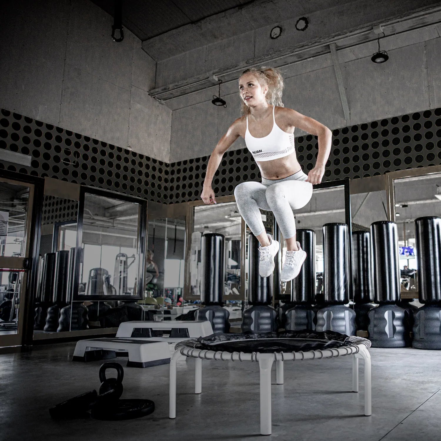Athlete working out on the ACON Fit 44in Round Rebounder with Active Handlebar during a Canadian indoor gym session.
