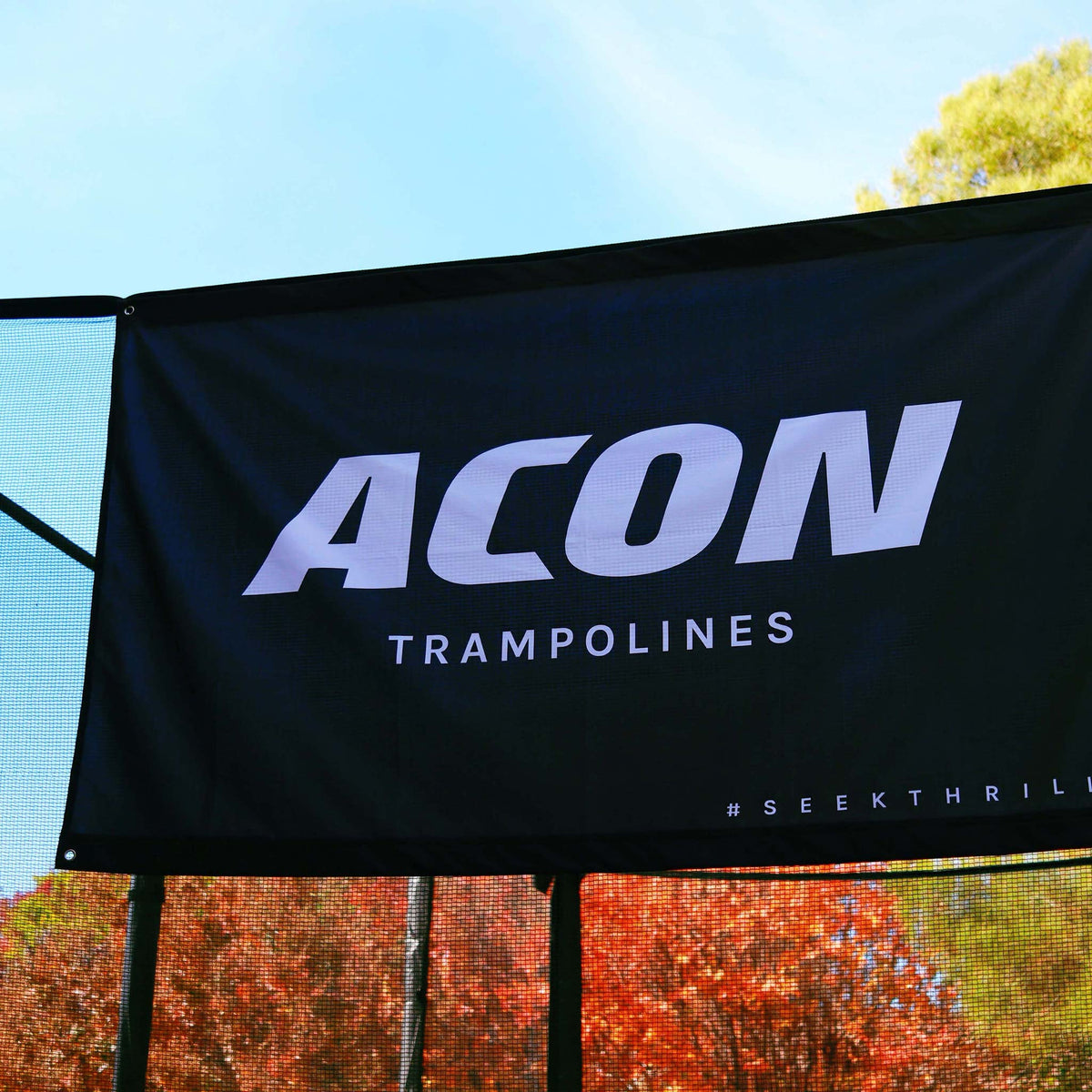 ACON Flag, Black close-up picture on trampoline colorful leafes on a background.
