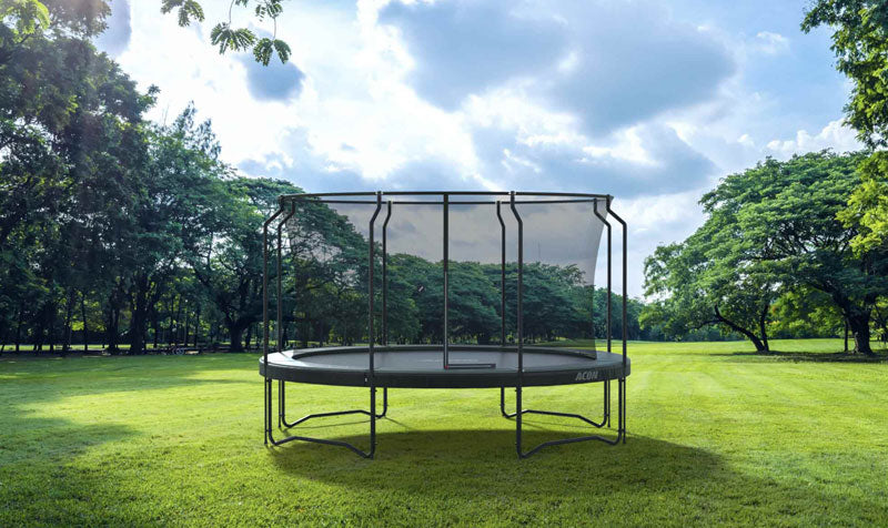 ACON trampoline with safety net outside on a grass