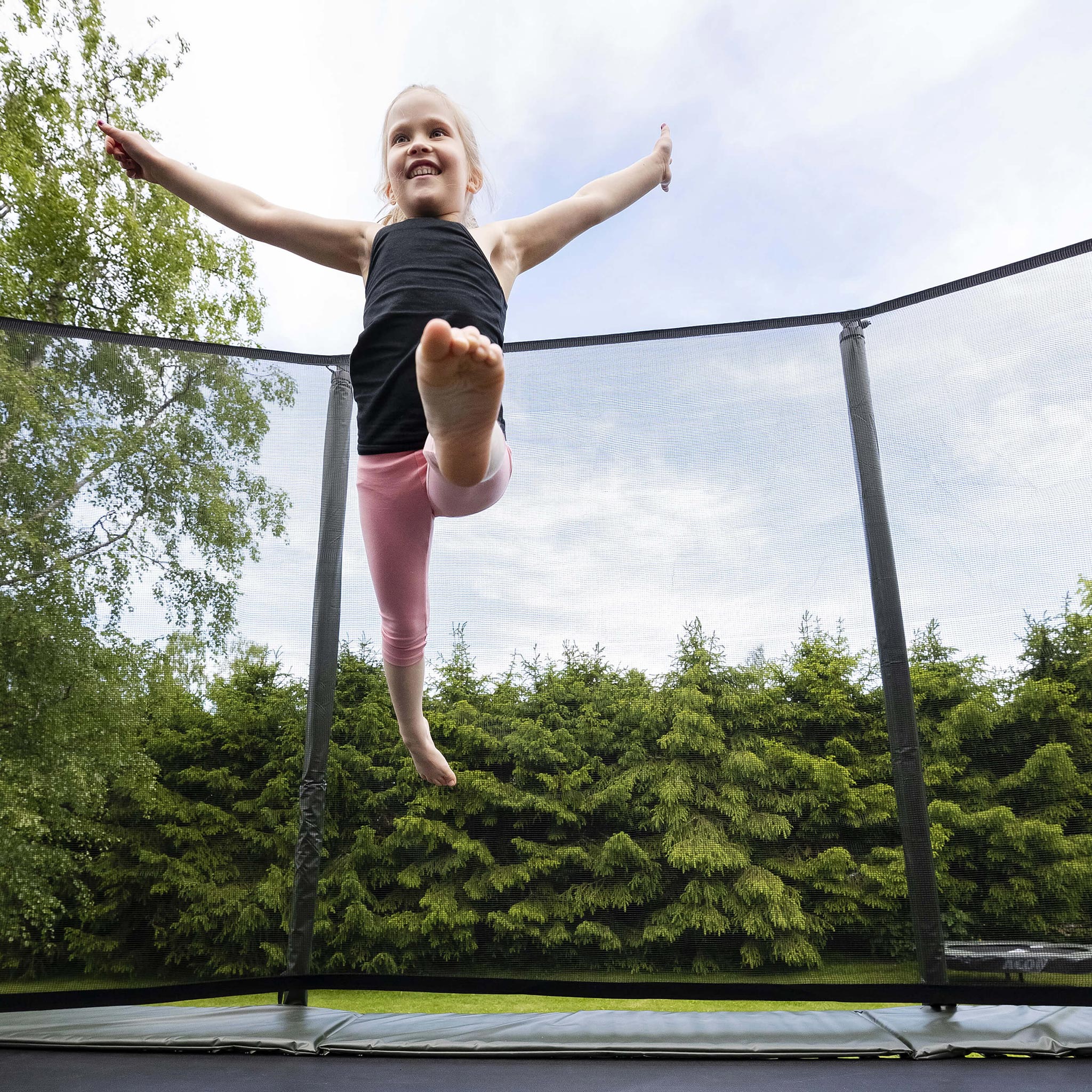 Acon HD Trampoline installed in the ground in the backyard.