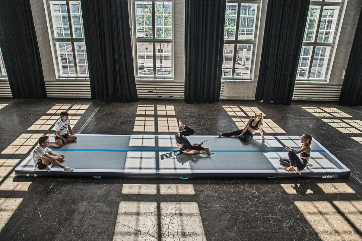 Five gymnasts on one big Airtrack