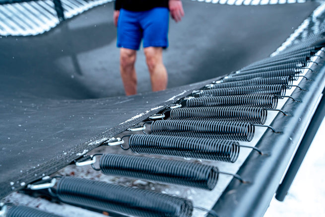 Jumper’s feet on acon trampoline mat with performance piano wire springs