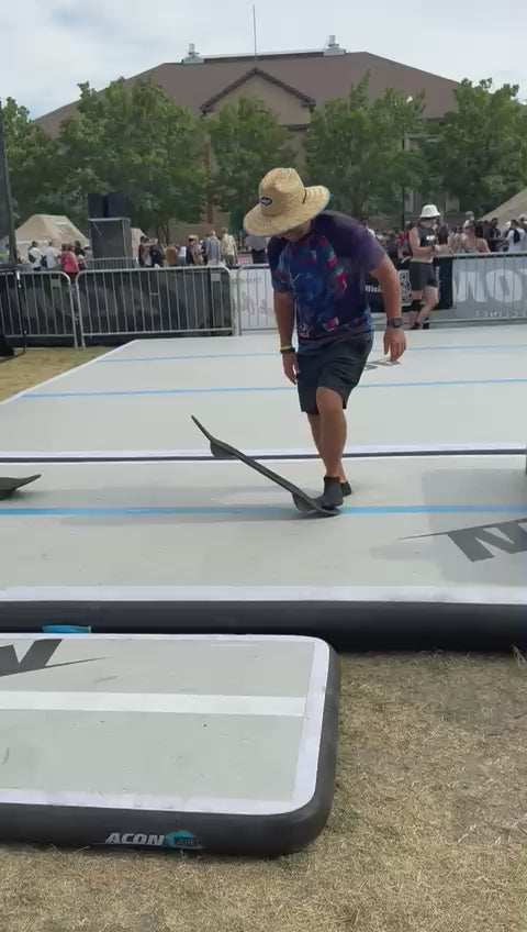 Video of a man testing Acon trampoline skateboard on a tumbling mat. 