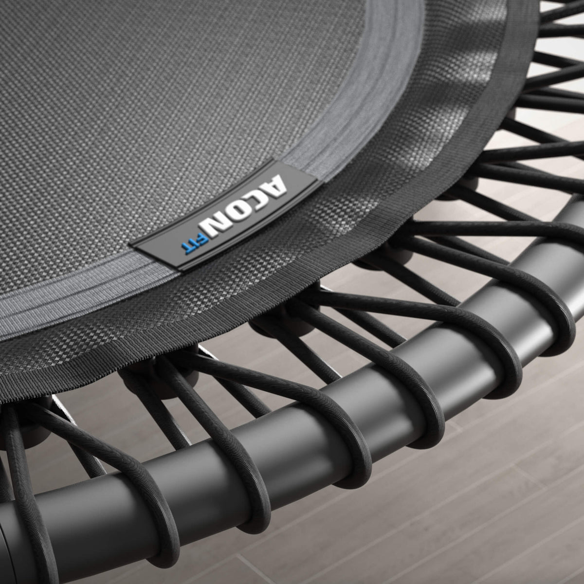 Close-up of the bungee cords of a white, round Acon FIT trampoline.