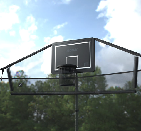 Outdoor image of the Acon Trampoline Hoop for a round trampoline and its Back Net, shot from below, showing blue sky and surrounding trees and clouds.